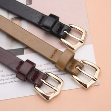 Close-up of slim PU leather belts with gold metal pin buckles in three versatile colors