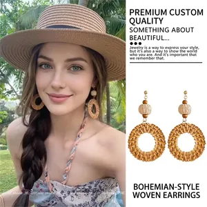 Bohemian handmade raffia hoop earrings shown on model in tropical sunlight