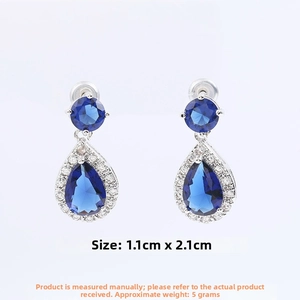 Detail view of pear-shaped blue zircon earrings with size specs of 1.1cm by 2.1cm