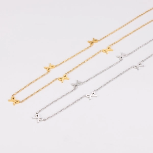 Minimalist stainless steel bow necklaces in gold and silver finishes on white background