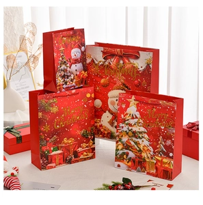 Multiple sizes of red Christmas gift bags with gold Merry Christmas lettering and snowman print