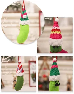 Detailed view of handmade felt pickle Christmas ornaments with colorful knitted Santa hats