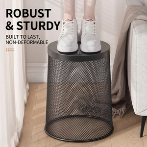 Durable black mesh metal waste basket showing strong weight capacity in home office setting