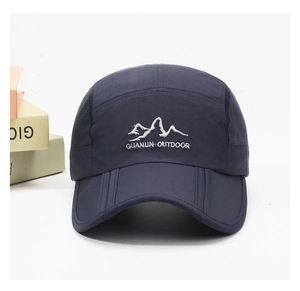 Detail of navy blue mesh outdoor cap with mountain embroidery and breathable fabric