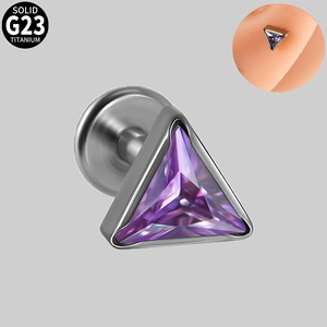 Macro detail of a G23 titanium labret stud featuring a triangular purple zircon stone