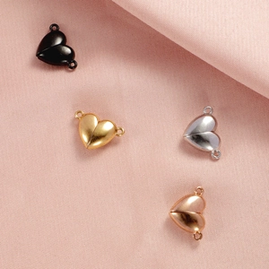Four heart-shaped magnetic jewelry clasps in black, gold, silver, and rose gold finishes
