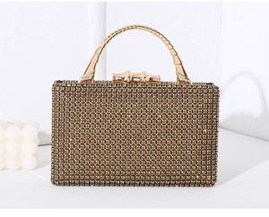 Detail of gold crystal evening bag featuring rhinestone mesh and metal bamboo handle