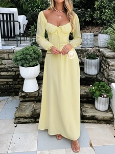 Detail of elegant pale yellow evening gown featuring square neckline and waist tie design