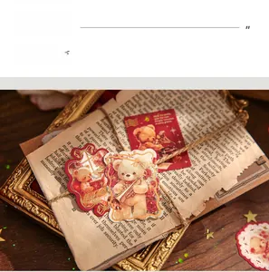 Detail of vintage bear stickers with gold foil edges on antique paper and wood background