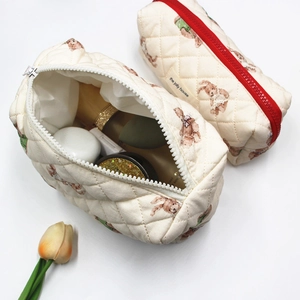 Quilted beige cosmetic bag set with teddy bear print and red zipper closure