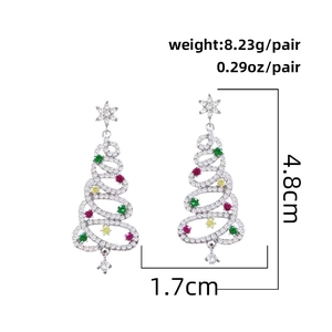 Macro view of Christmas tree earrings with colorful stones and precise measurements