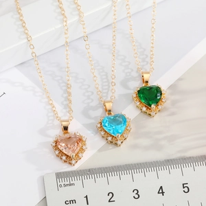 Minimalist gold heart crystal pendant necklaces in pink, blue, and green stones
