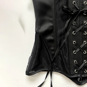 Detailed view of the corset back with satin ribbons and metal eyelet lacing structure