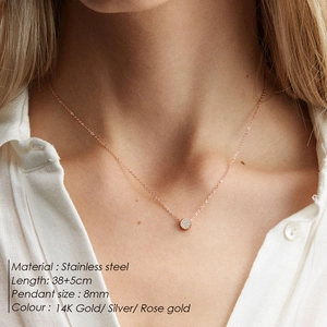 Close-up of 8mm pave crystal circle pendant in rose gold finish on stainless steel chain