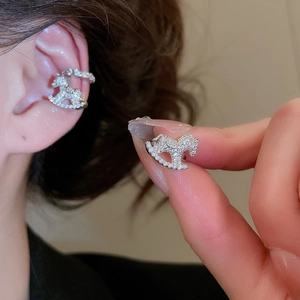Detailed view of a silver rocking horse ear cuff featuring sparkling pavé zircon stones