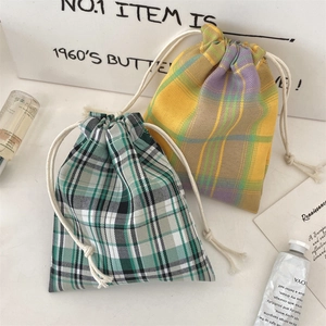 Close-up of checkered drawstring storage bags with cotton rope in plaid patterns