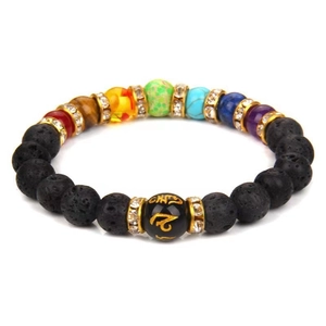 Detailed macro view of 7 chakras volcanic stone bracelet with golden mantra charm