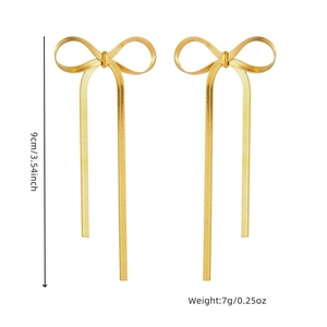Gold bow tassel earrings in stainless steel with 9cm snake chain drop on white background