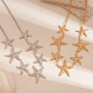 Vintage gold and silver starfish waist chains with crinkled metallic texture and charms
