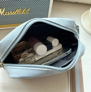 Top view of spacious interior storage in a light blue lychee pattern crossbody bag