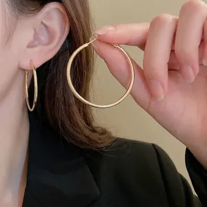 Elegant gold-tone round hoop earrings for women showing minimalist design and polished finish