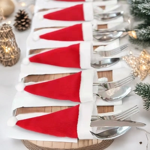 Mini Christmas hat cutlery holders in red and white fabric for festive table decoration