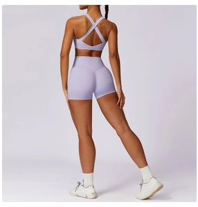 Detail view of the criss-cross back sports bra and high-waisted shorts in lavender