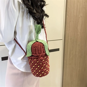 Cute strawberry shaped handmade woven bucket bag with green leaf top and red shoulder strap