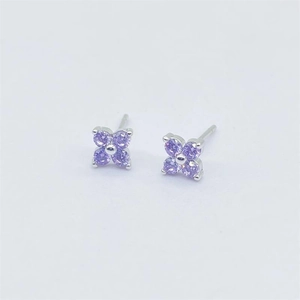 Detailed close-up of S925 sterling silver four-leaf flower earrings with purple crystals