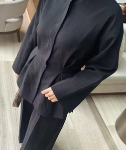 Detail shot of the high-quality woven black minimalist long sleeve shirt and trousers set