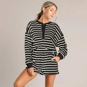 Detail of striped long-sleeve Henley top and elastic shorts in soft knit fabric