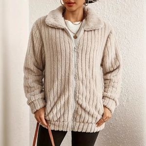 Detail of beige striped plush fabric texture on women's winter coat with zipper