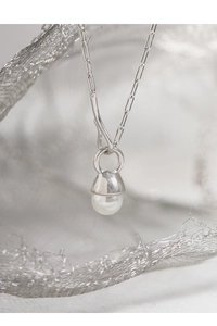 Macro shot of S925 sterling silver long-link chain necklace with white pearl pendant