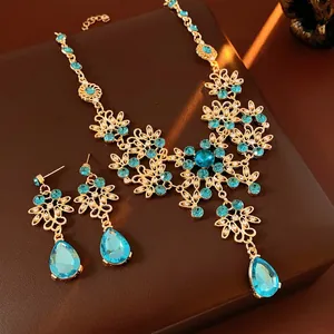 Vintage gold crystal jewelry set with blue floral necklace and matching teardrop earrings
