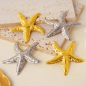 Detailed view of gold and silver starfish pendants in 304 stainless steel with textures