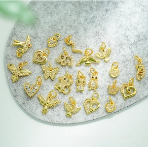 Macro view of 18K gold plated animal pendants with micro-paved white zircons for DIY jewelry