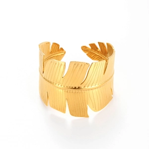 Adjustable wide gold stainless steel cuff bracelet featuring a tropical leaf cutout design