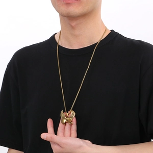 Golden eagle pendant necklace for men in stainless steel worn by a male model