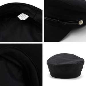 Black vintage newsboy cap with cotton blend fabric and decorative metal button detail