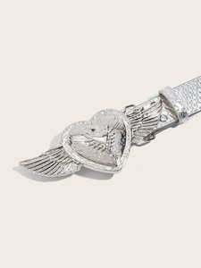 Close-up of silver textured belt featuring a unique winged heart buckle detail