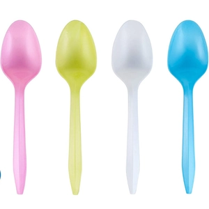 Set of colorful plastic spoons in pink, green, white and blue for unicorn parties