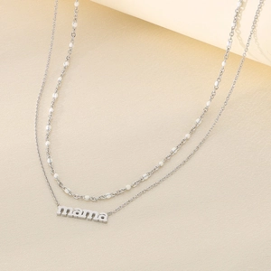 Detail of silver layered necklace with mama pendant and delicate beaded chain style