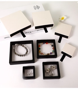 Detail view of white drawer boxes and black floating PE film frames for jewelry storage