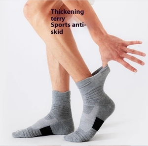 Detail view of grey cushioned sports socks with thick terry sole and anti-slip grip