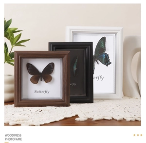 Three deep wood, black, and white shadow boxes featuring 3D real butterfly specimens