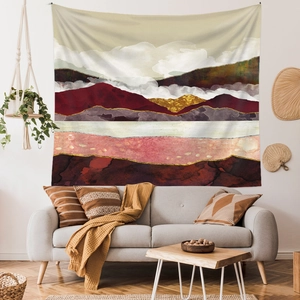 Abstract tapestry showing mountain landscape with burgundy and gold accents above sofa