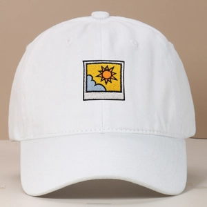 Macro shot of white cotton baseball cap featuring minimalist embroidered landscape patch