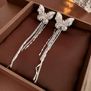 Silver butterfly chain tassel ear cuff with sparkling cubic zirconia on brown leather