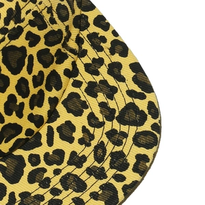 Macro shot of high-quality leopard print fabric and reinforced stitching on a flat brim cap