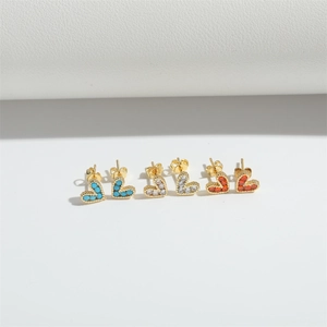 Three pairs of small heart stud earrings with blue, white and orange zircon in gold settings